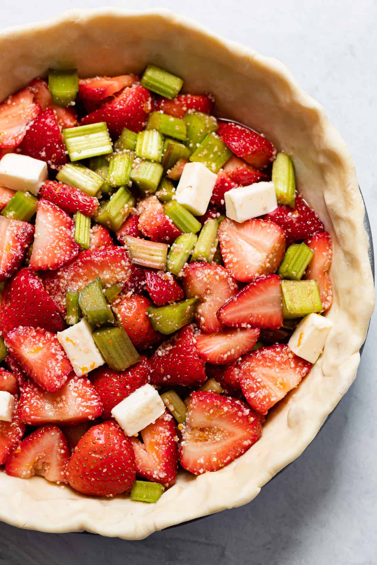 Strawberry rhubarb filling in an unbaked pie shell.