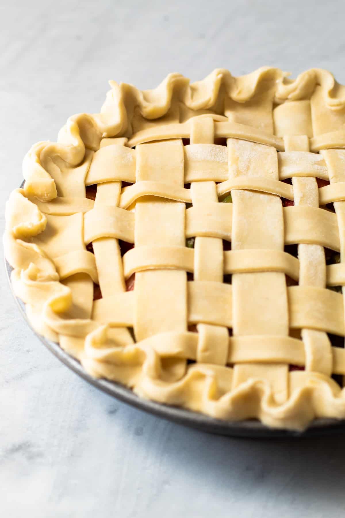 A unbaked pie with a decorative crust.