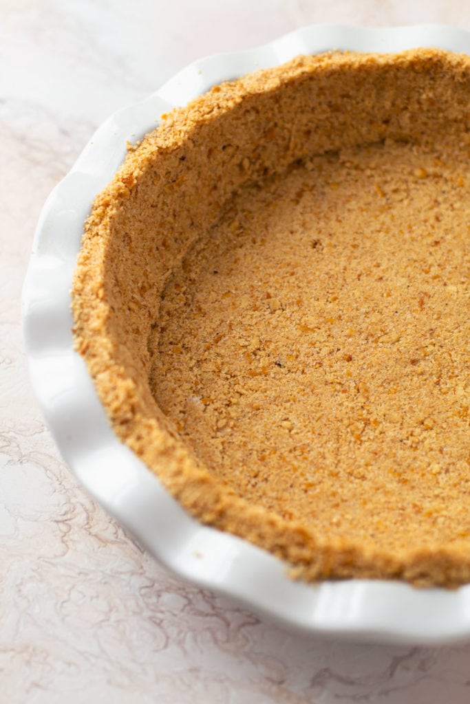 A pretzel crumb crust in a pie plate.