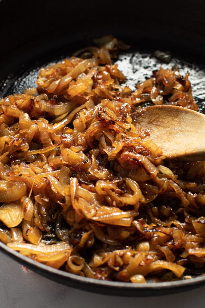 Jammy caramelized onions in a cast iron pan.