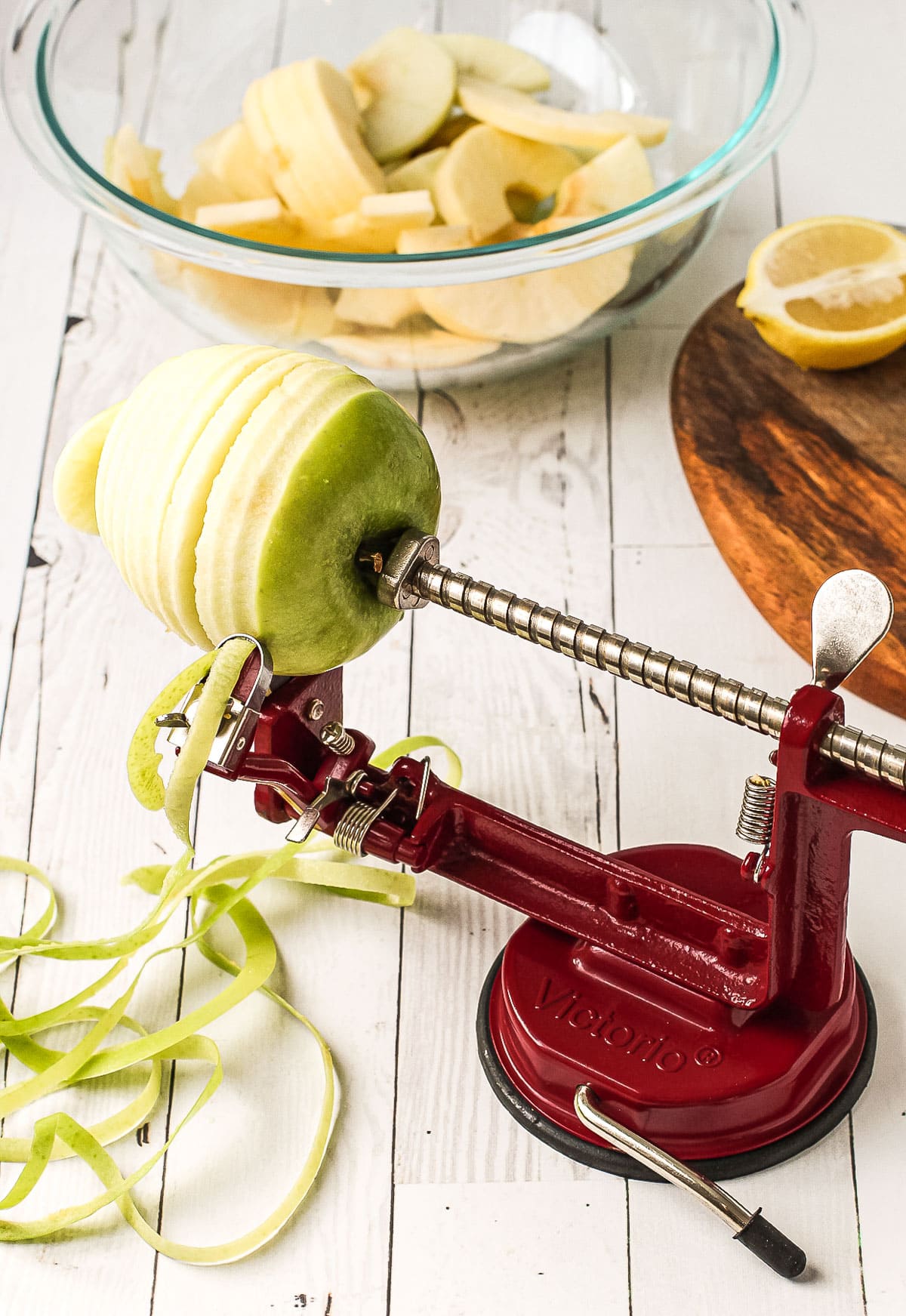 Apple being peeled on a Johnny apple peeler.