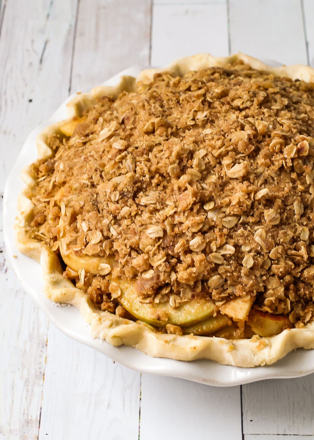 Crumble topping on an unbaked apple pie.