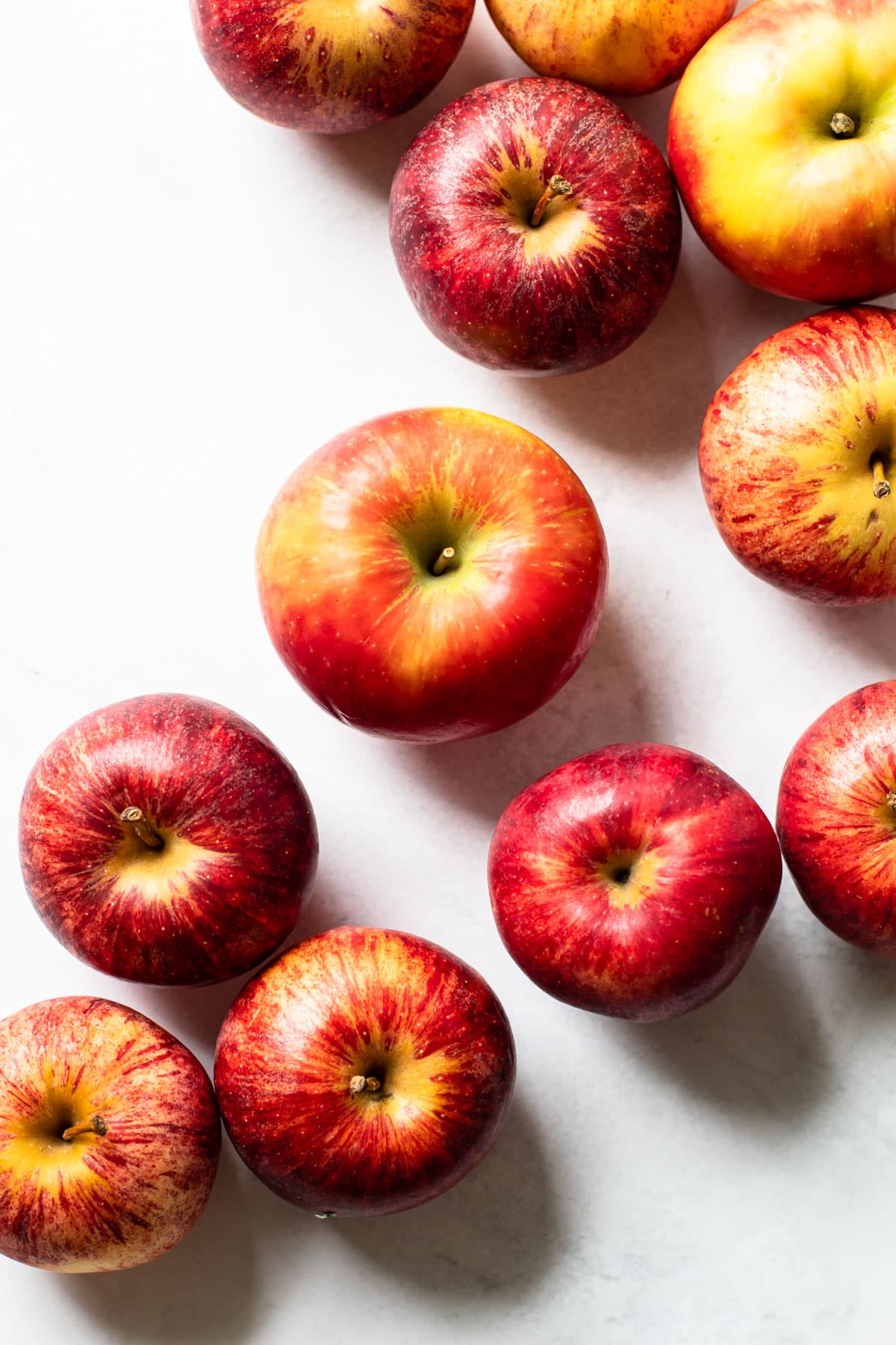 Half a dozen apples on a white background.