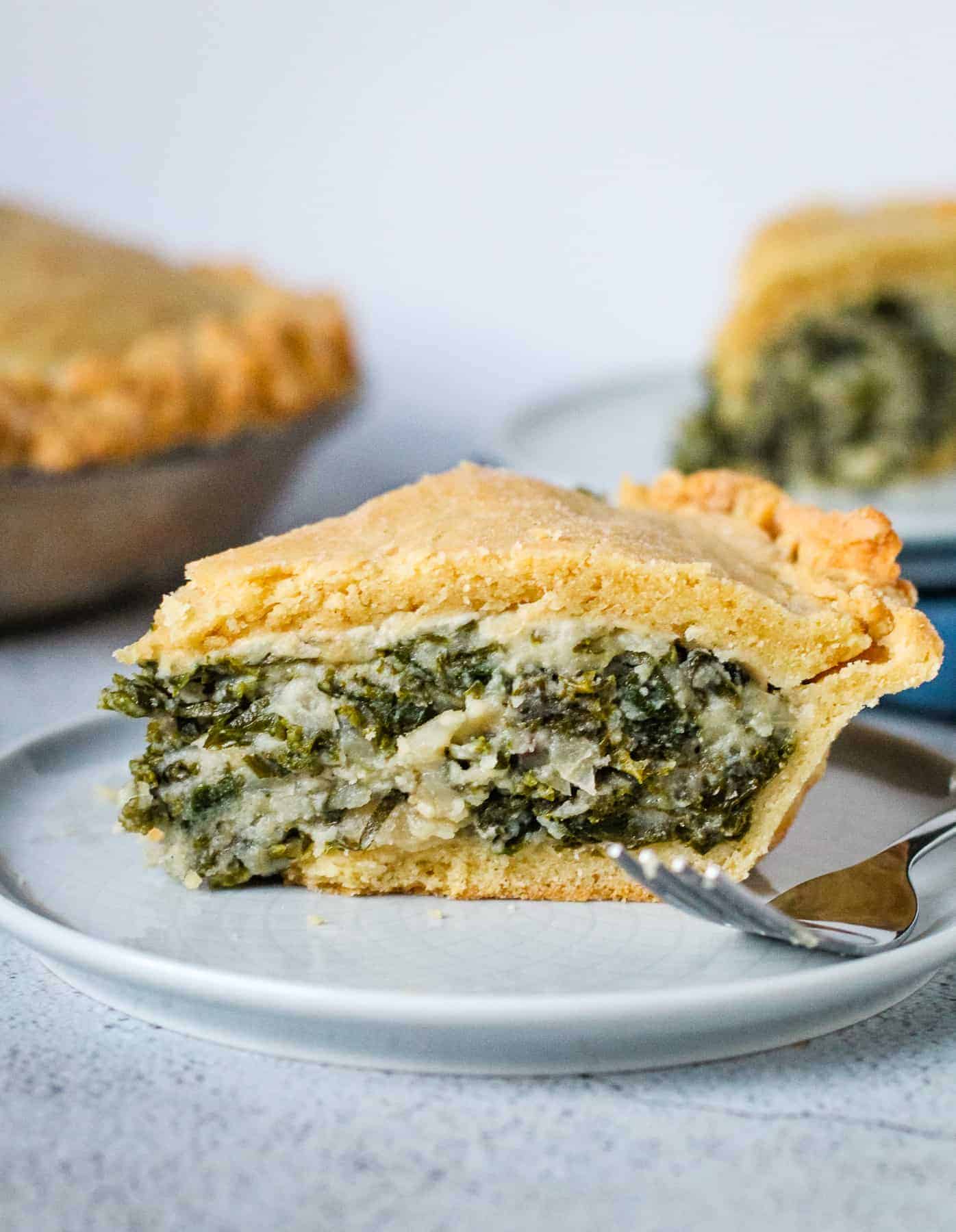 Kale pie on a plate with a fork