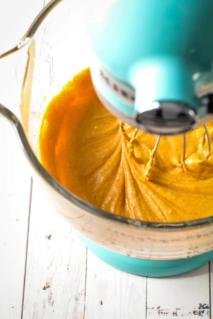 A no bake pumpkin pie filling mixture in a stand mixer with canned pumpkin.
