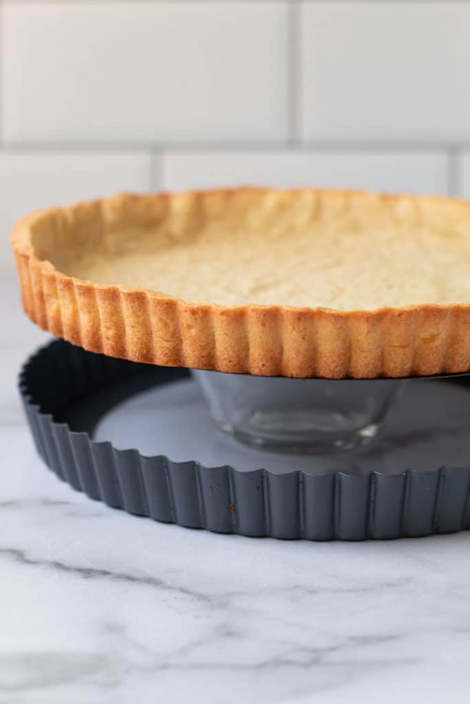 Pate Sablee pie dough being taken out of the tart pan.