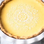 Lemon Custard Pie with a powdered sugar decorative design.