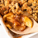 A scoop of healthy apple crisp with pecan oat crumbles.
