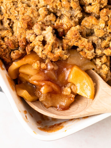A scoop of healthy apple crisp with pecan oat crumbles.