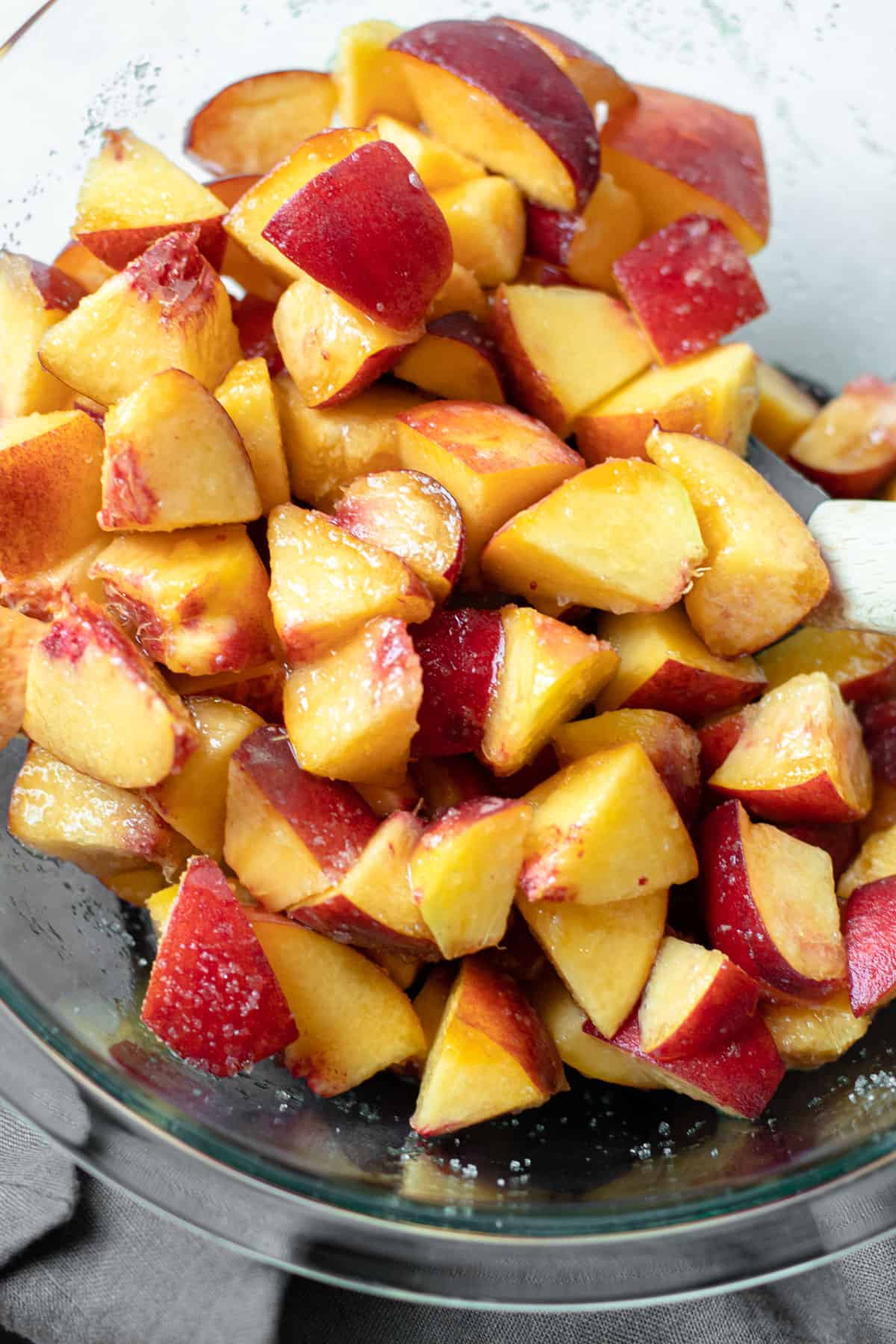 Diced Peaches with sugar in a bowl.