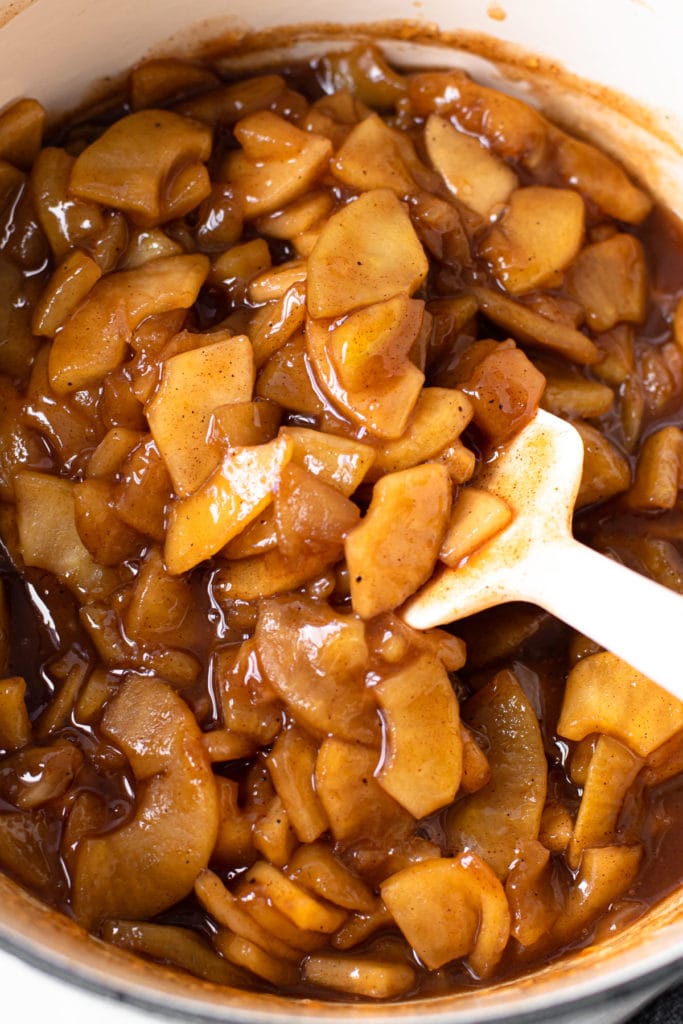 Cooked apple pie filling in a pot.