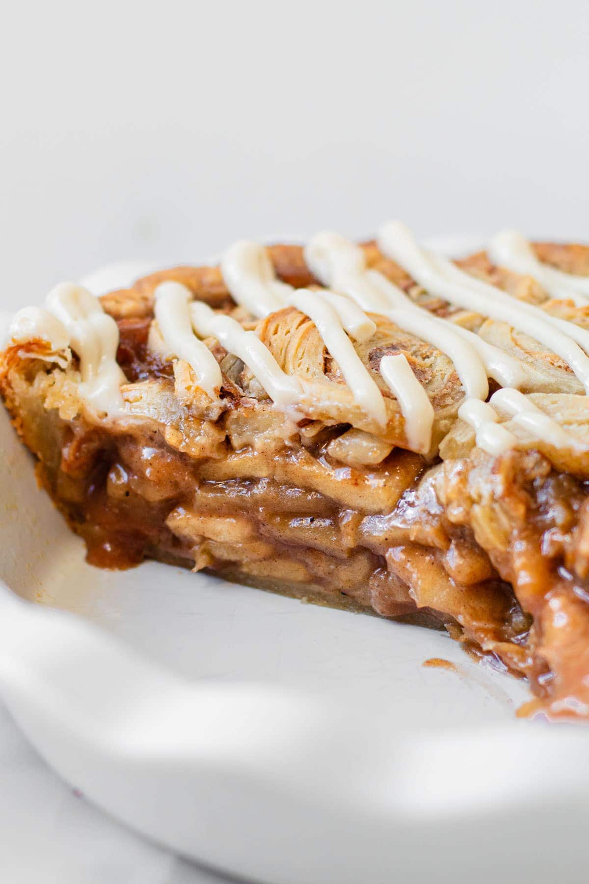 A profile view of cinnamon roll apple pie.