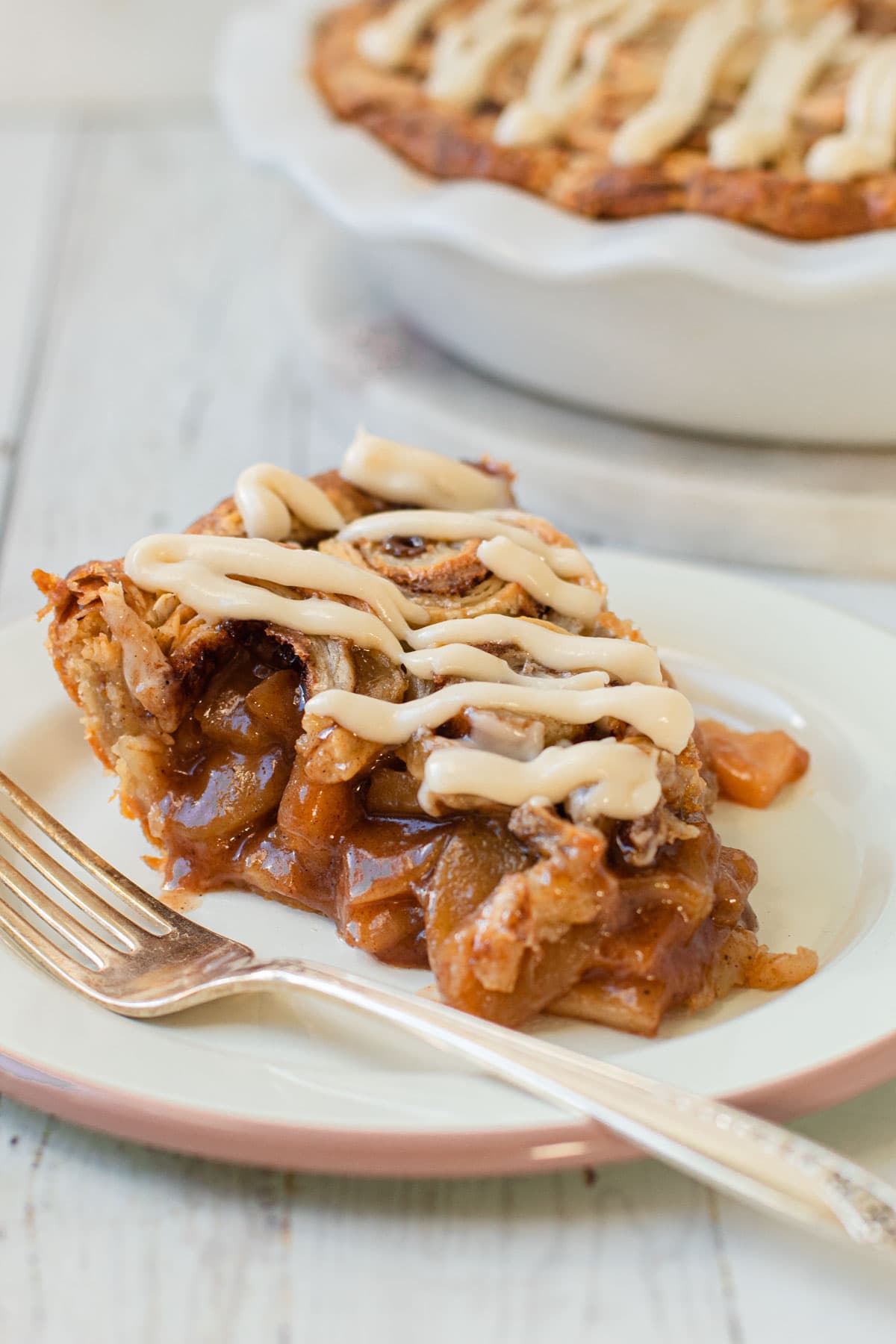 A slice of cinnamon roll apple pie.