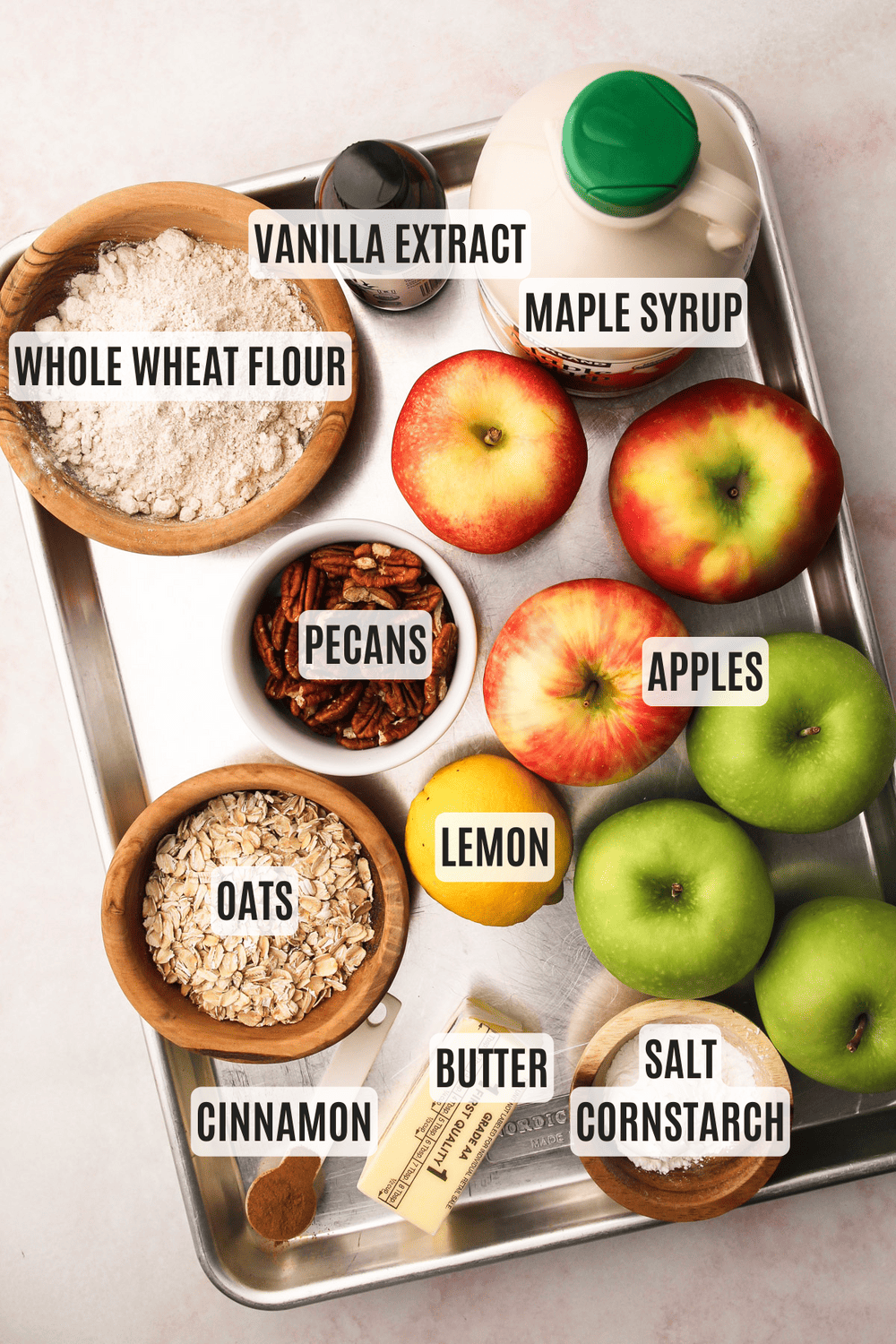 Ingredients on a sheet tray measured for making a healthy apple crisp recipe.
