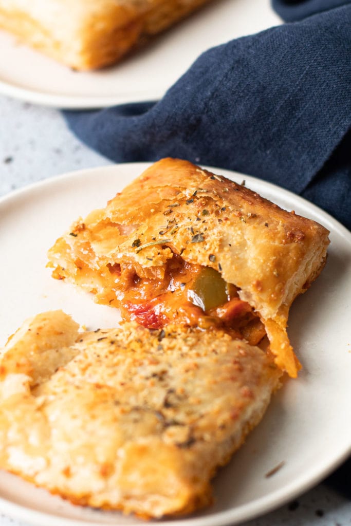 Pizza hand pies on a plate.