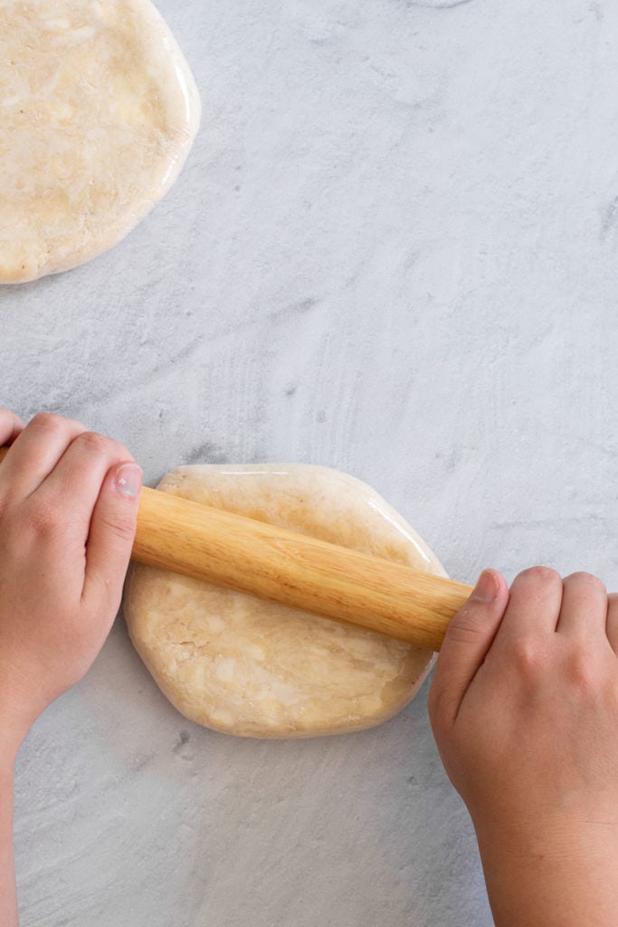 Rolling pie dough out.