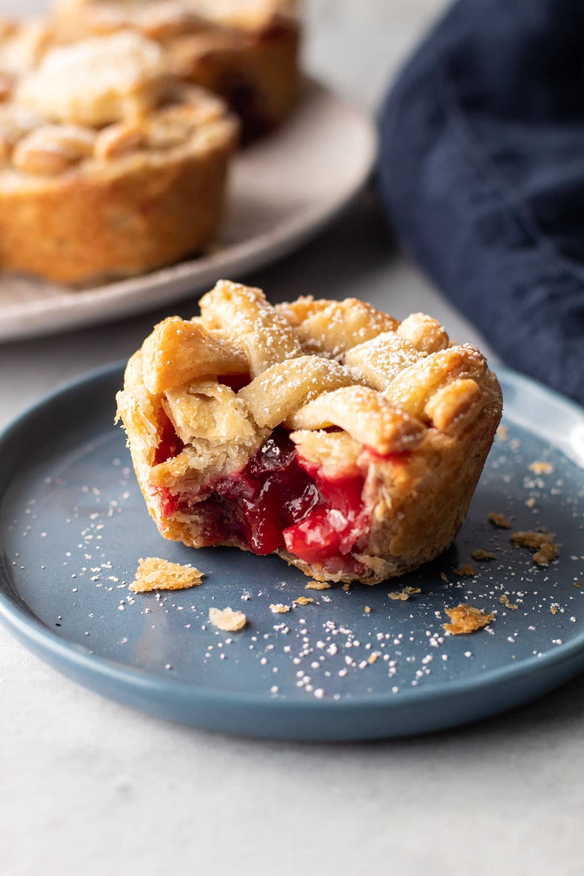 Mini cranberry pear pie on a plate.