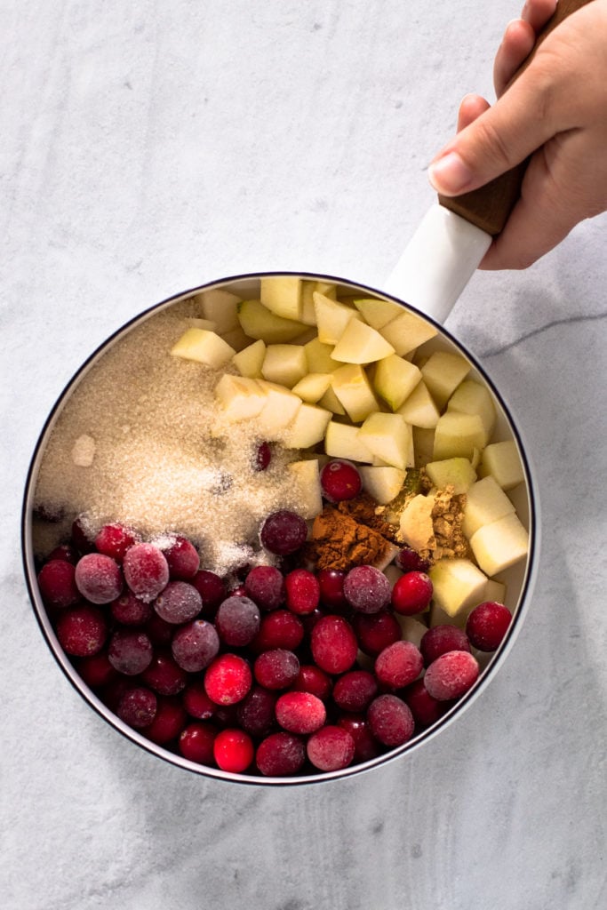 Ingredients for cranberry pear pie filling in a pot.