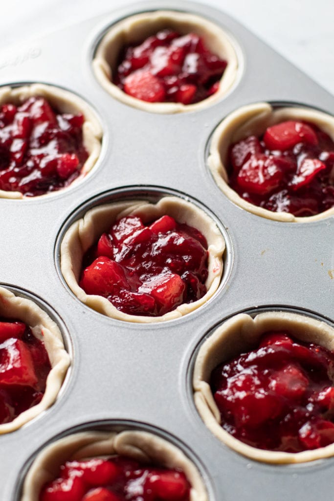 Mini pie filling in a muffin tin.