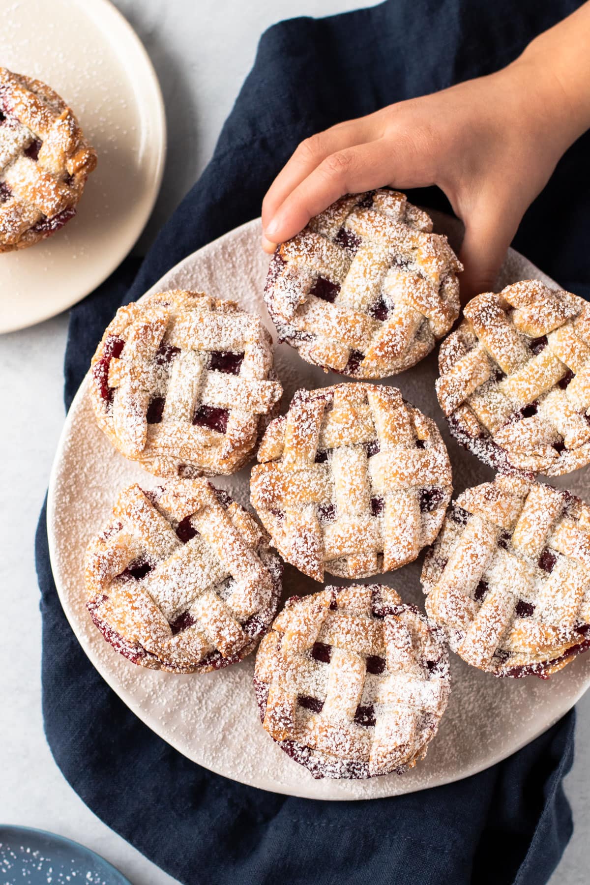 Mini cranberry pear pies on a plate.