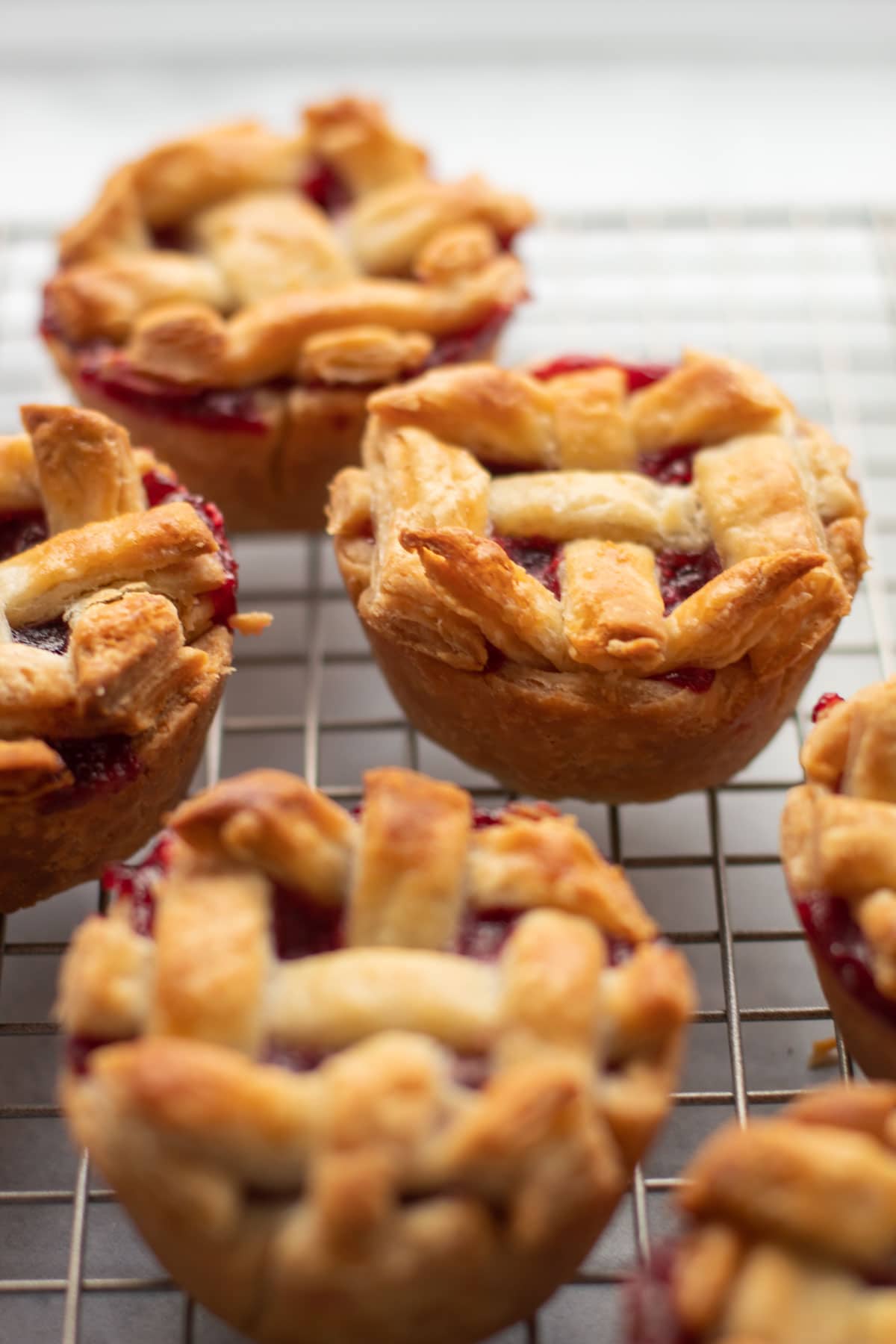 Cranberry Pear Pies cooling on a rack.