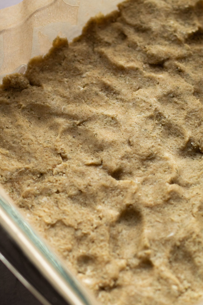 Pumpkin pie shortbread crust in a baking pan.