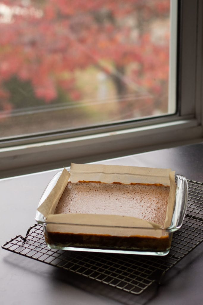 Pumpkin pie bars cooling on a rack.