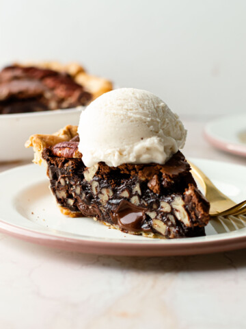 A slice of brownie pecan pie with ice cream on top.
