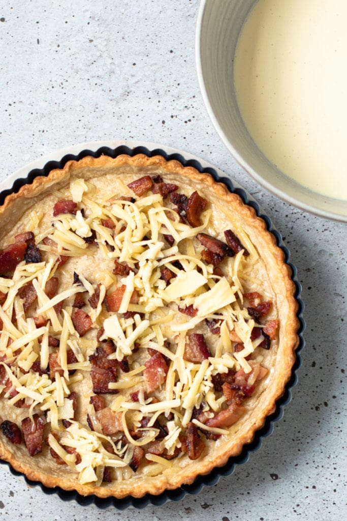 Bacon and cheese in a quiche Lorraine parbaked quiche crust.