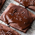 Chocolate Pop Tarts on a cooling rack with chocolate glaze.