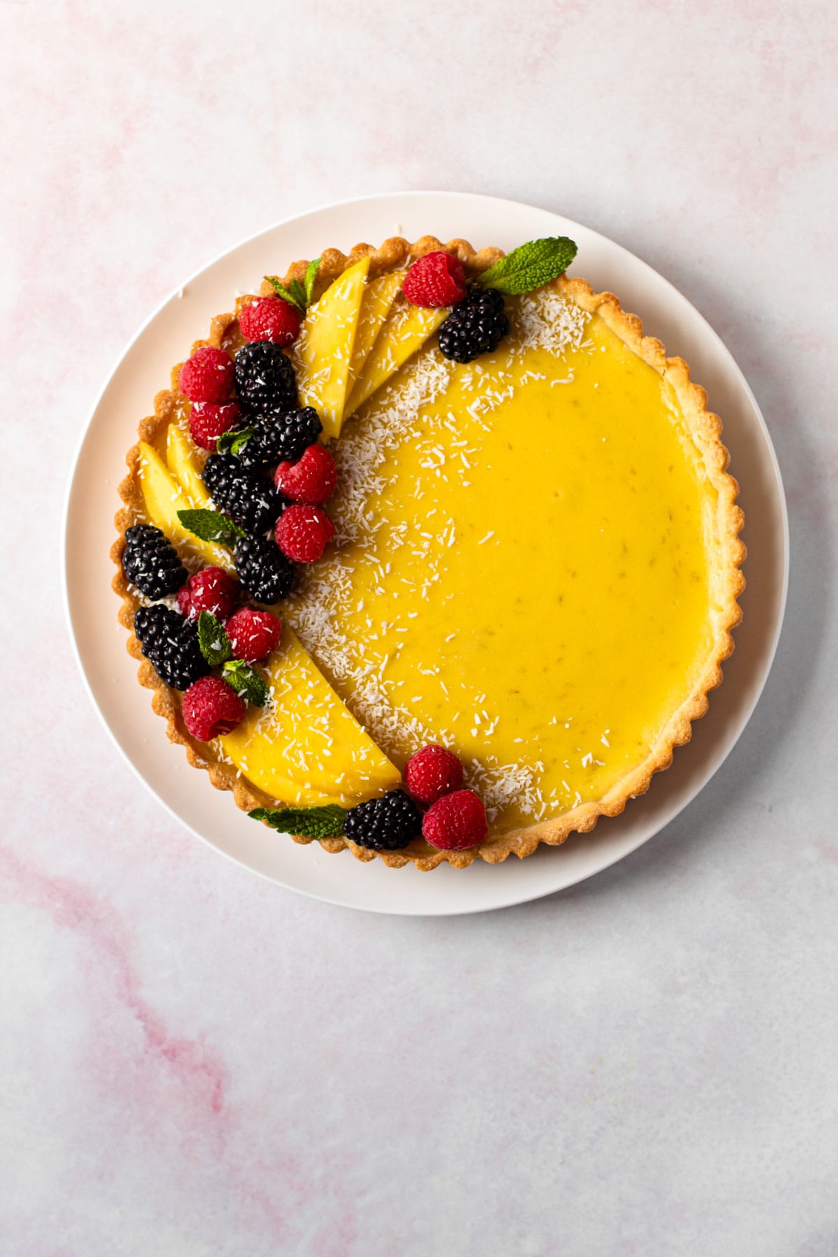 A baked and decorated coconut lime tart.