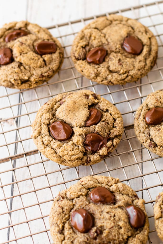 Oat flour chocolate chip cookies with buckwheat on a metal cooling rack.