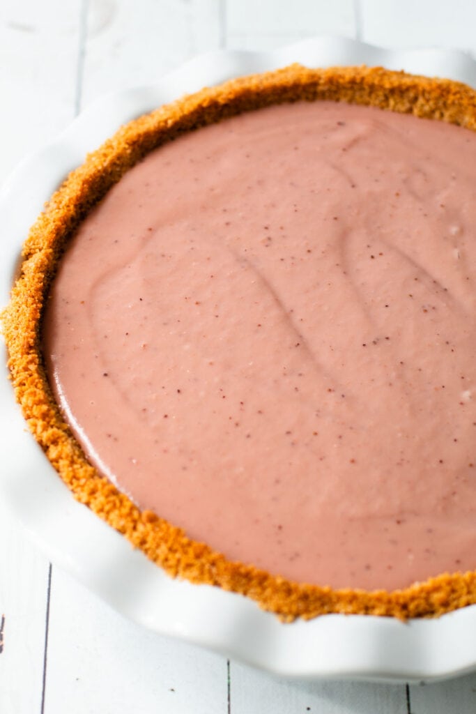 Strawberry pudding inside of a strawberry cream pie.