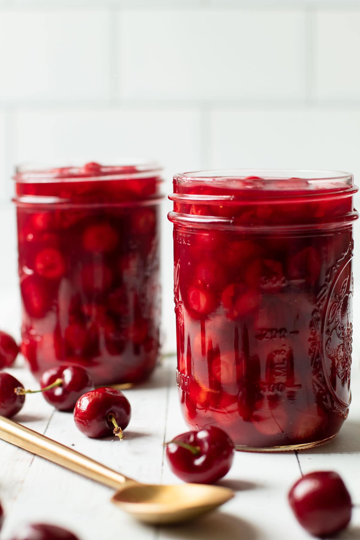 Two jars of sour cherry pie filling.