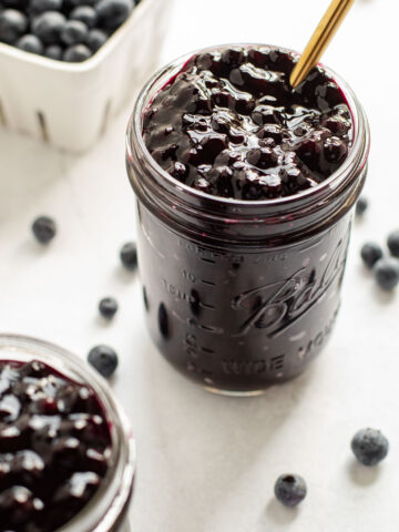 Two jars of blueberry pie filling.