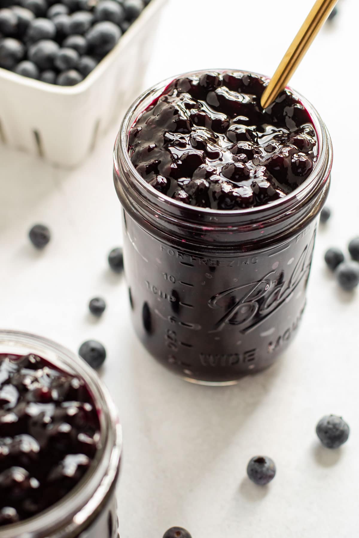 Two jars of blueberry pie filling.