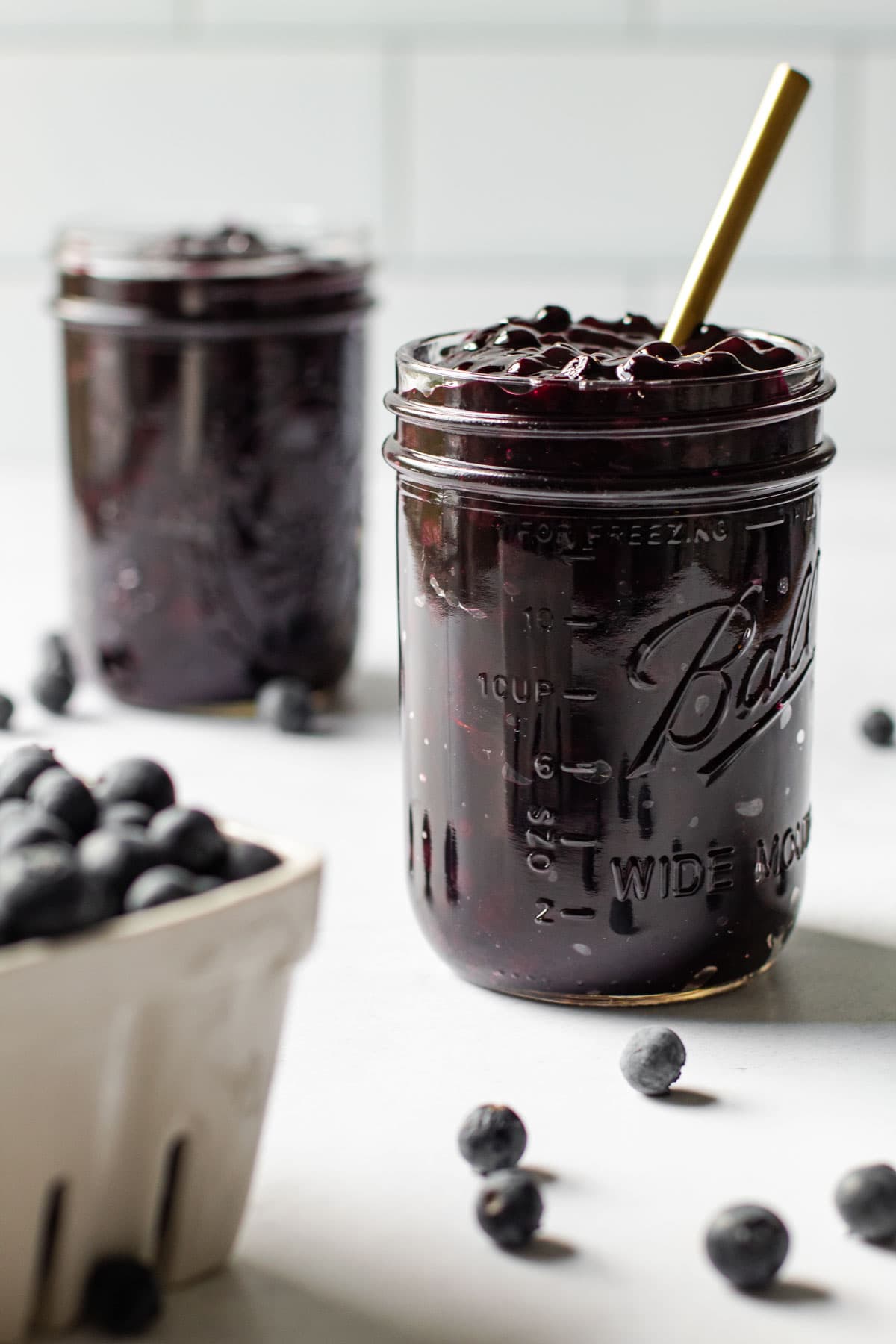 Two jars of blueberry pie filling.