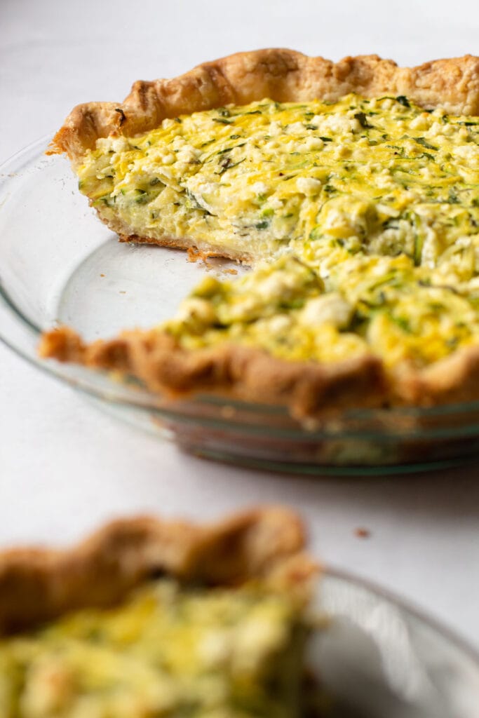 A sliced zucchini pie in a pie plate.