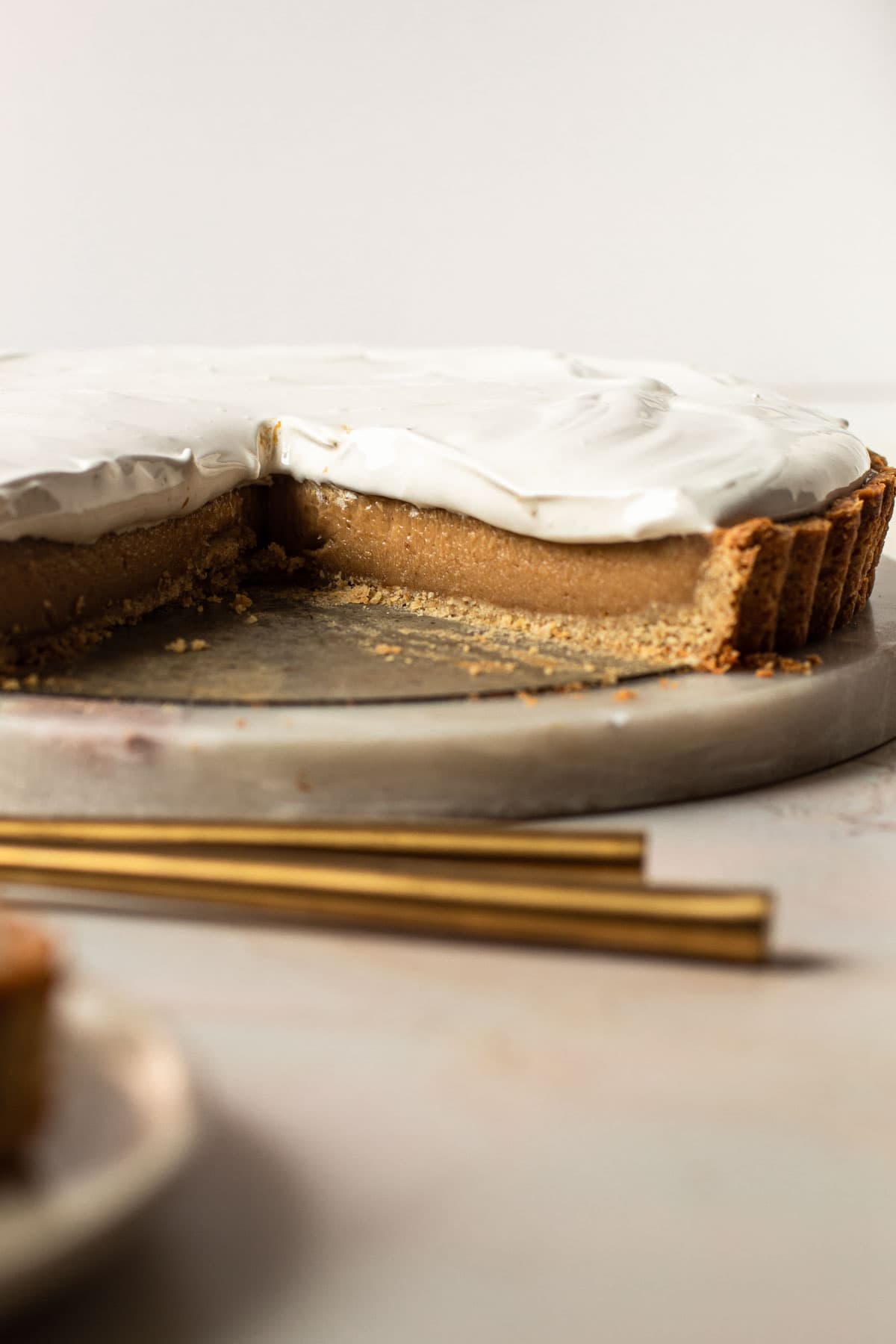 A fluffernutter pie with a slice removed to reaveal the creamy peanut butter filling.