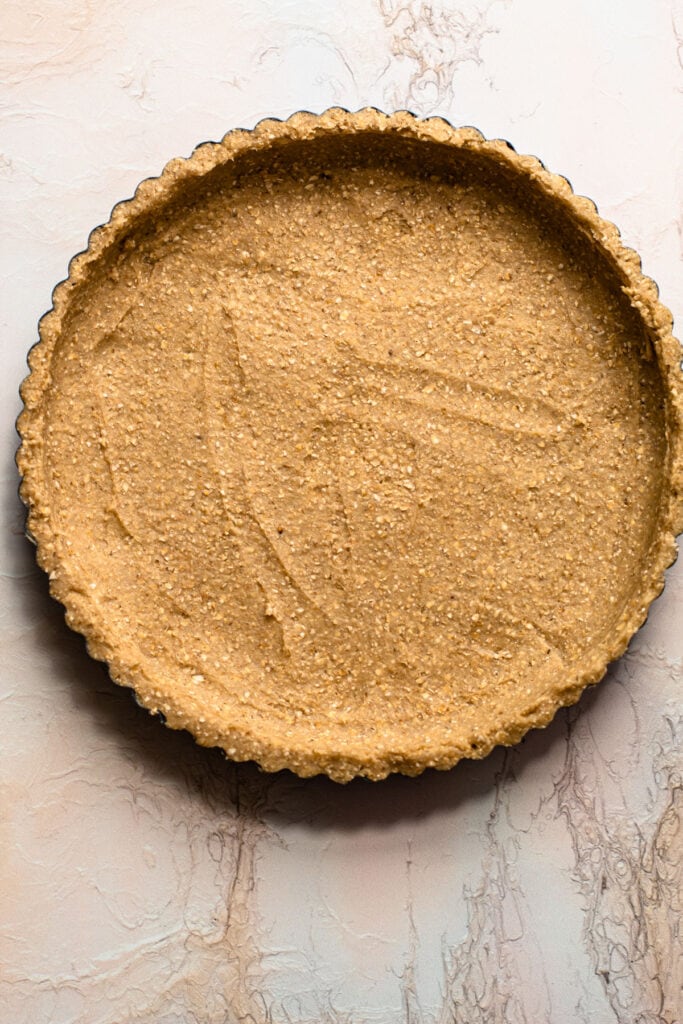 Oat shortbread crust in a tart tin.