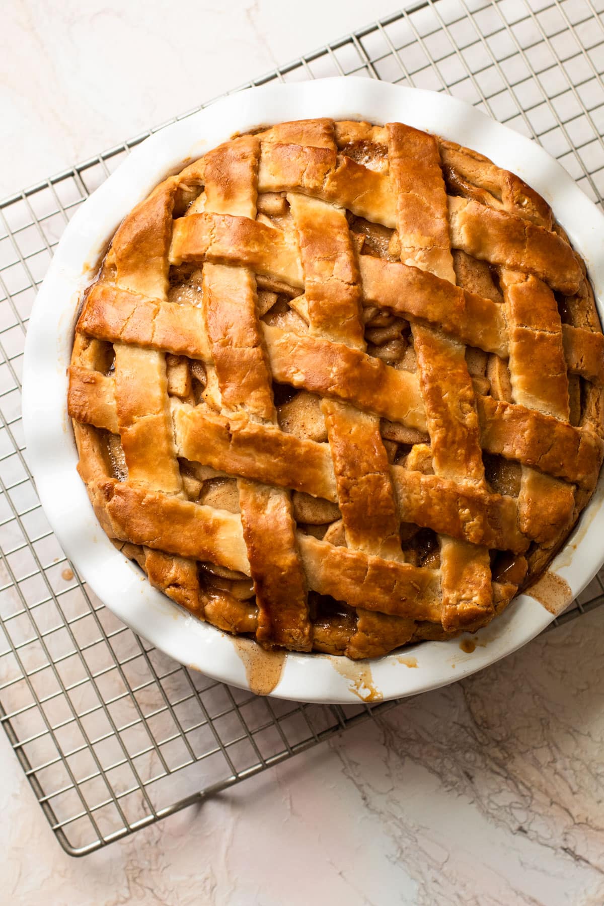 A fully baked gluten-free apple pie with a beautiful lattice.