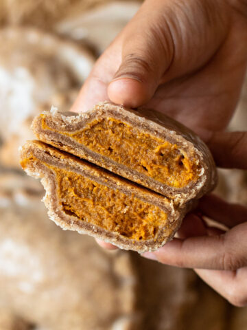 A pumpkin pasty cut in half to reveal a creamy filling.