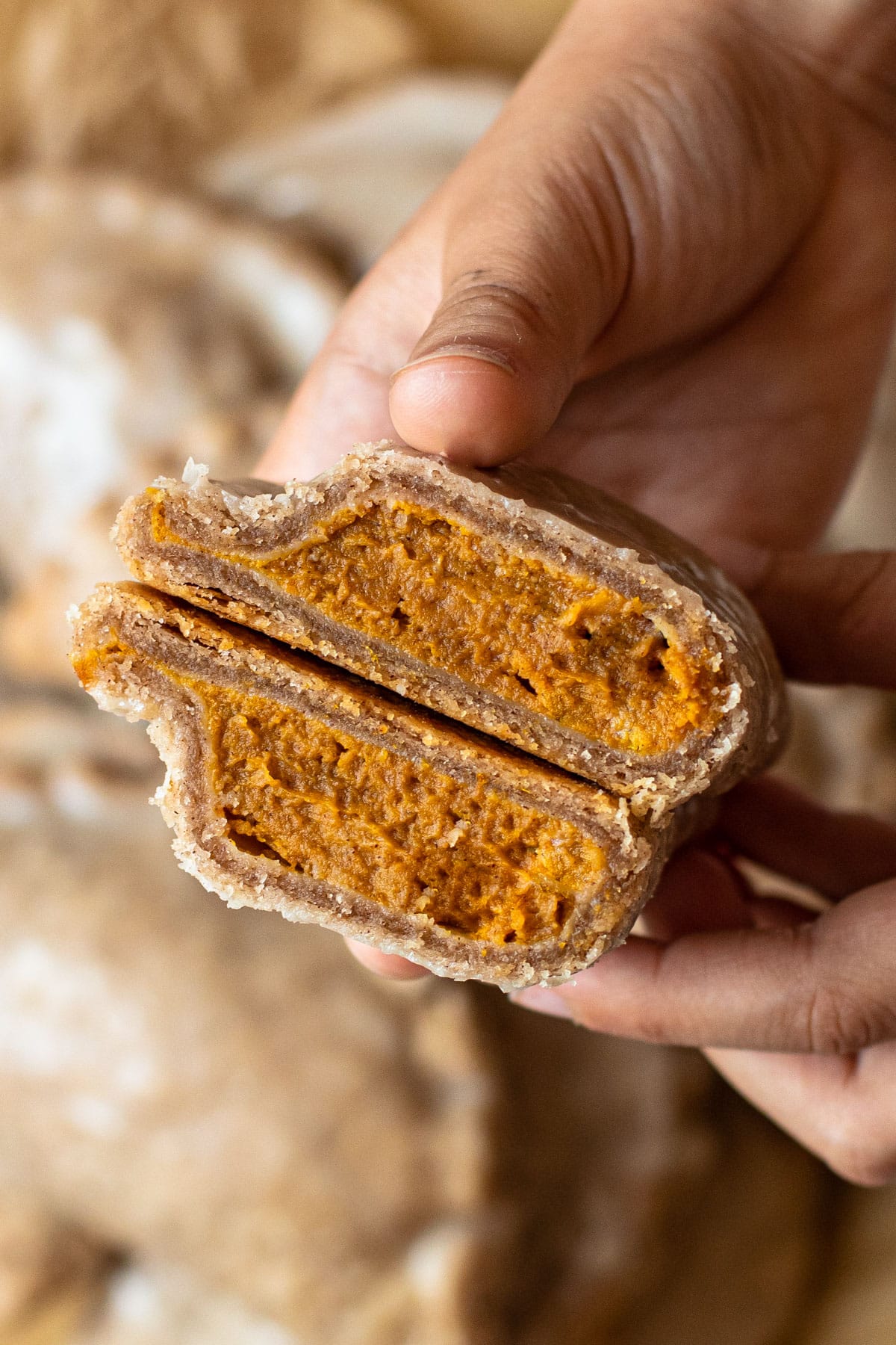 A pumpkin pasty cut in half to reveal a creamy filling.