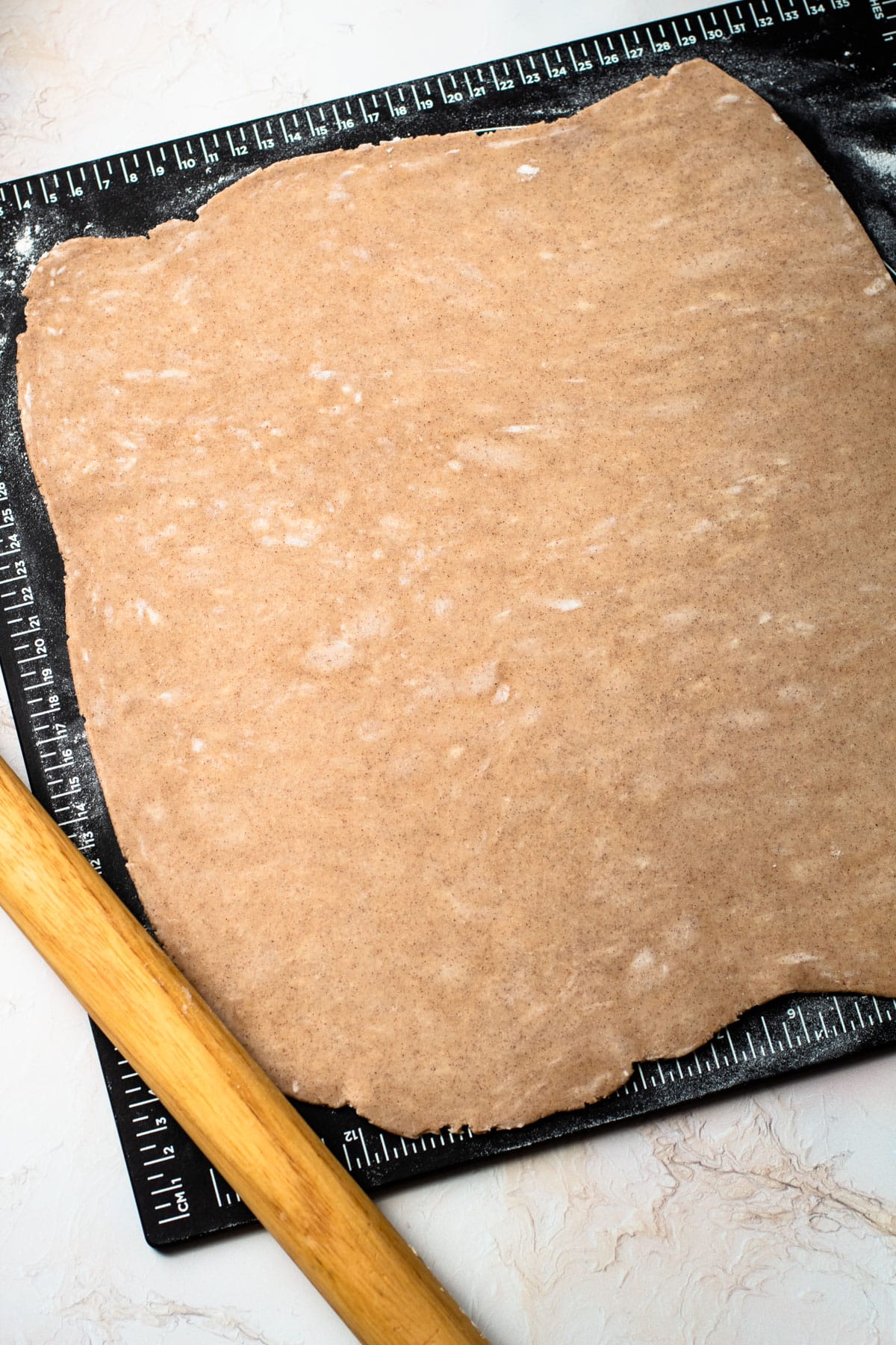 Dough for pumpkin pasties rolled out.