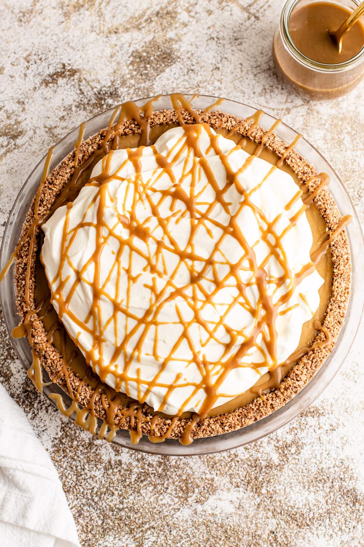 Butterscotch cream pie with drizzled butterscotch over the top.