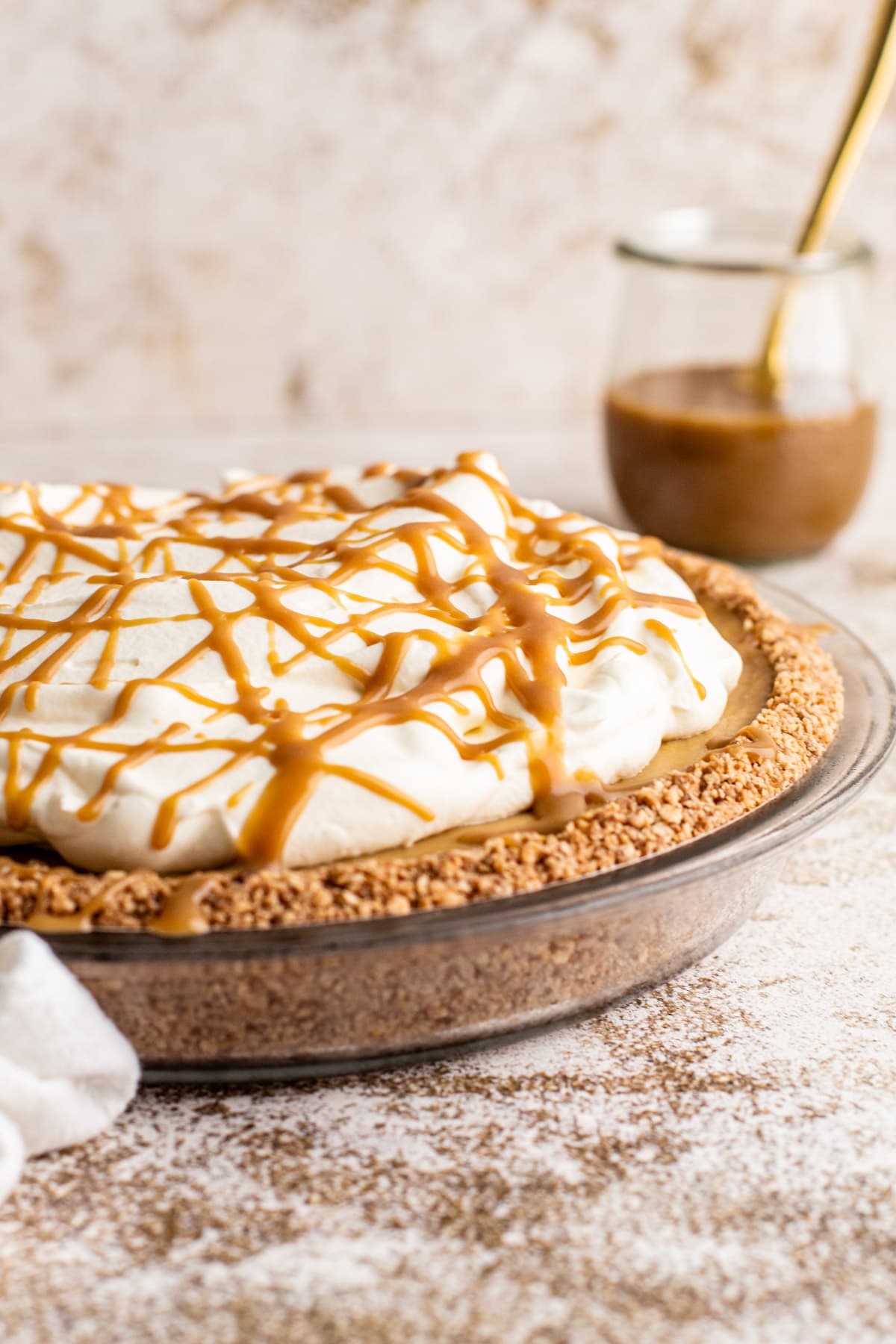 Butterscotch cream pie with whipped cream and a drizzle of butterscotch.