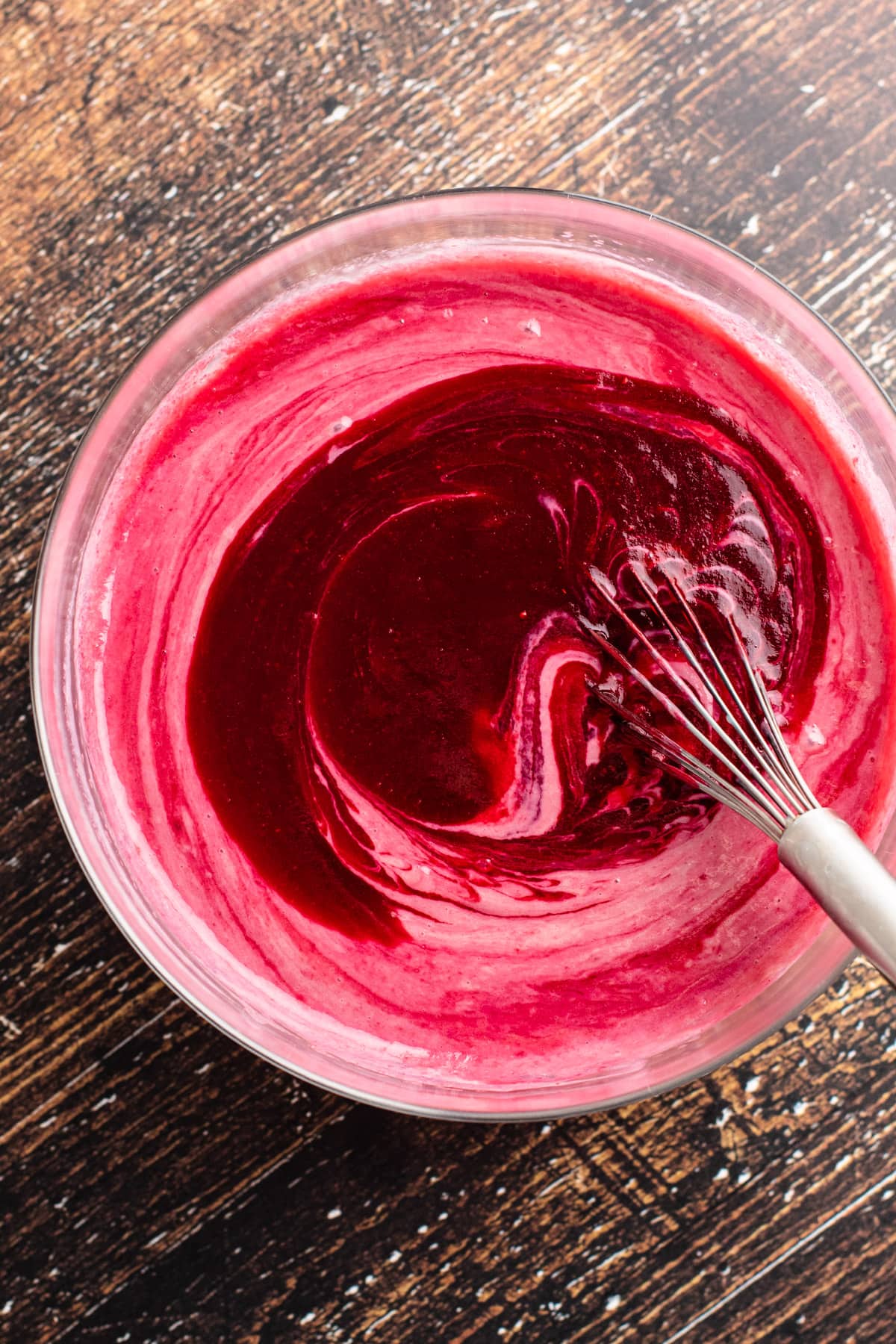 A bowl of cranberry puree with sweetened condensed milk for cranberry custard pie.