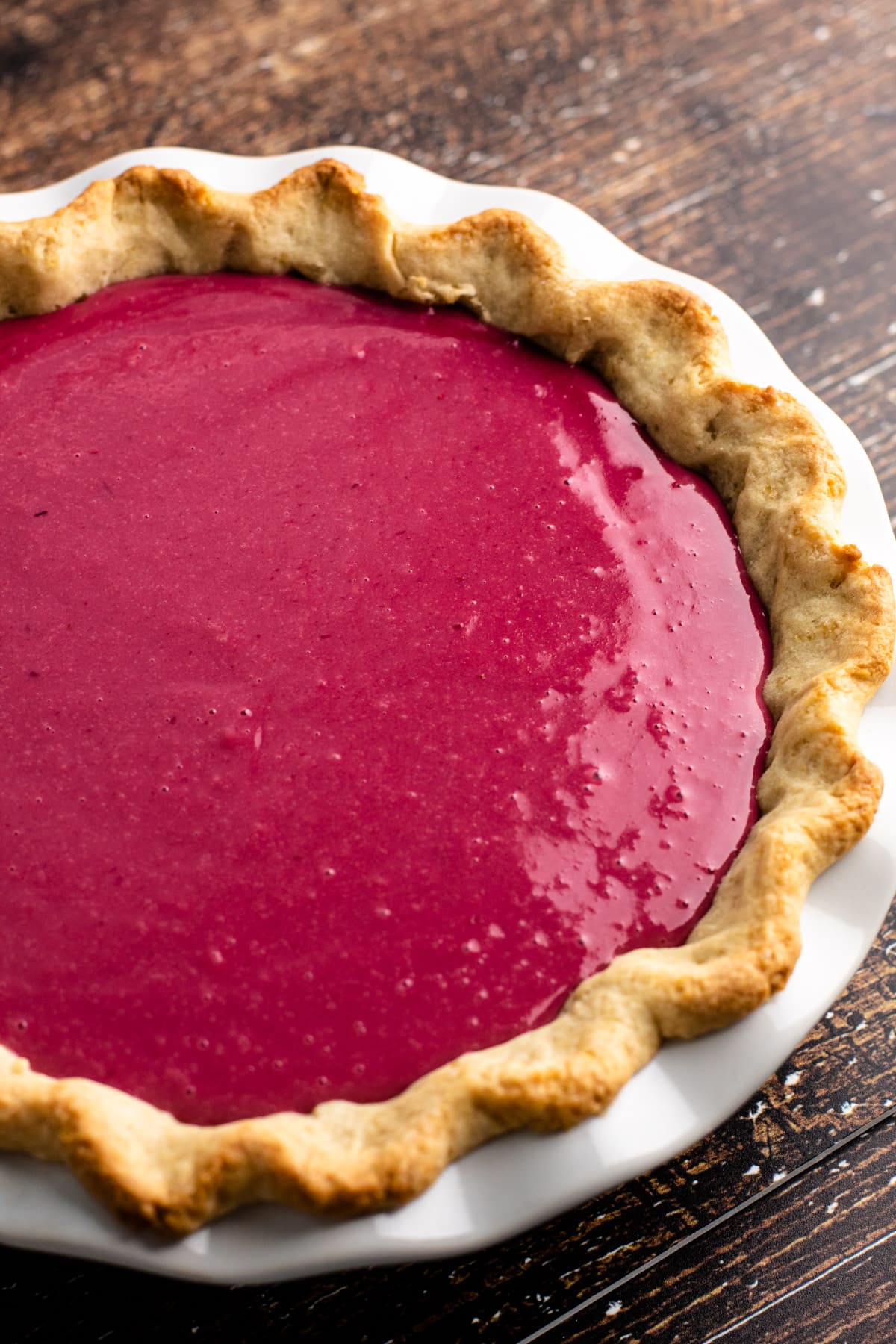 An unbaked cranberry custard pie.