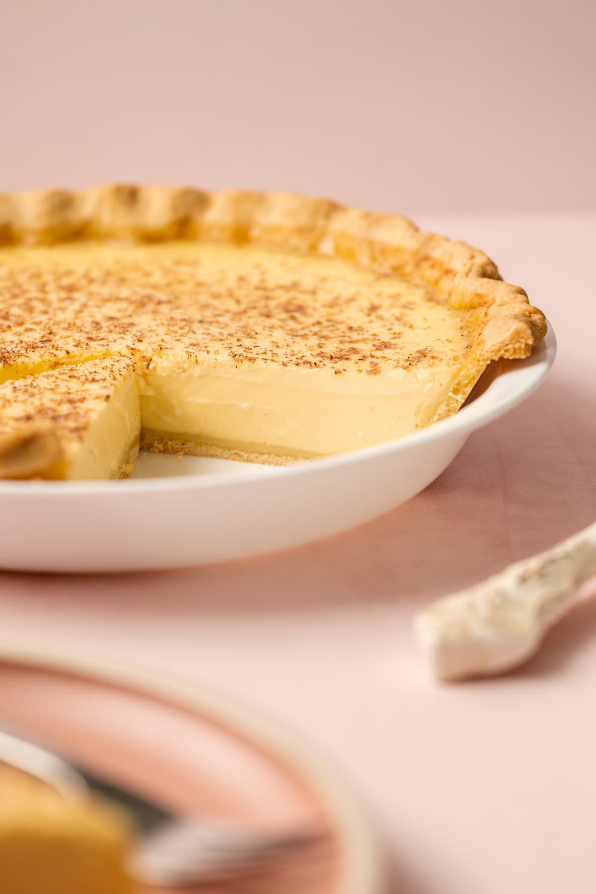 A custard pie with a slice removed.