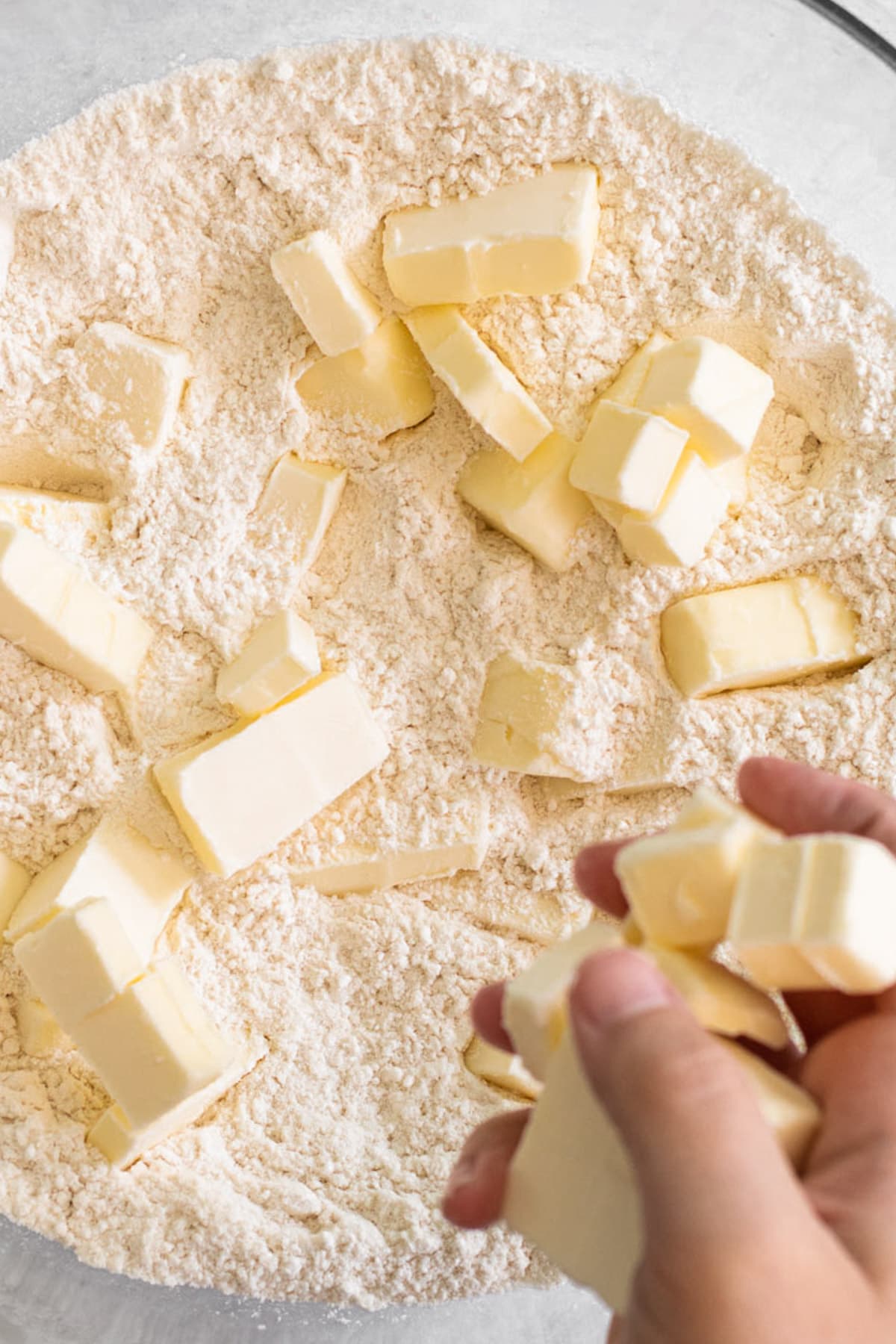 Butter in a bowl with flour to make pie crust.